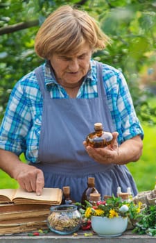 Medicinal herbs alternative medicine old woman. Selective focus. Nature.