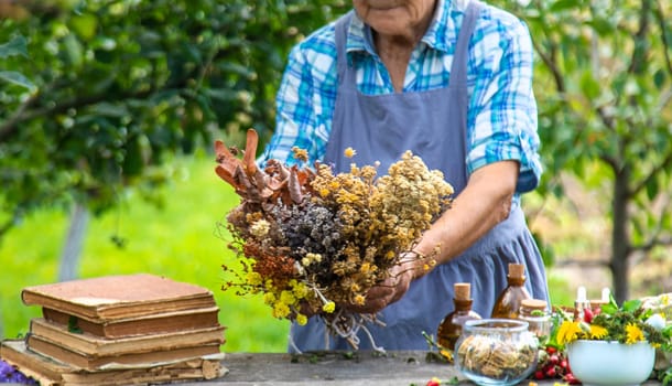 Medicinal herbs alternative medicine old woman. Selective focus. Nature.