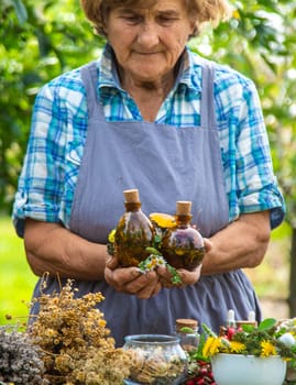 Medicinal herbs alternative medicine old woman. Selective focus. Nature.