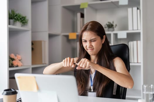 An office worker shows frustration and stress at their desk, highlighting workplace challenges and burnout.