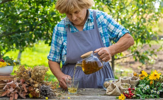 Medicinal herbs and tea old woman. Selective focus. Nature.