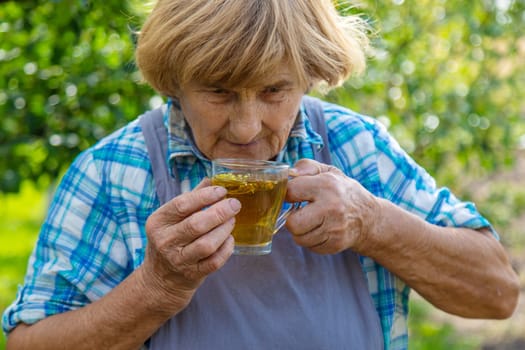 Medicinal herbs and tea old woman. Selective focus. Nature.