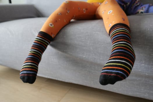 Close up of a colorful soft socks on child feet