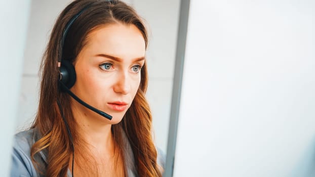 Business people wearing headset working in office to support remote customer or colleague. Call center, telemarketing, customer support agent provide service on telephone video conference call. Jivy