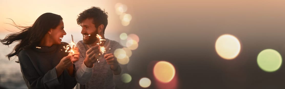 Happy couple, sparkle and love by the beach with mockup space and bokeh with travel and smile. Travel, holiday and anniversary with freedom at sunset by the sea and ocean on vacation with joke.