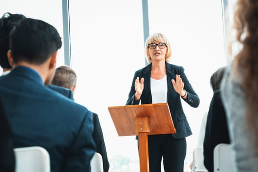 Group of business people meeting in a seminar conference . Audience listening to instructor in employee education training session . Office worker community summit forum with expert speaker . Jivy