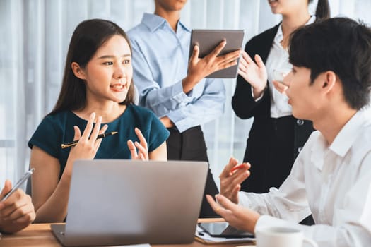 Happy diverse business people work together, discussing in corporate office. Professional and diversity teamwork discuss business plan on desk with laptop. Modern multicultural office worker. Concord