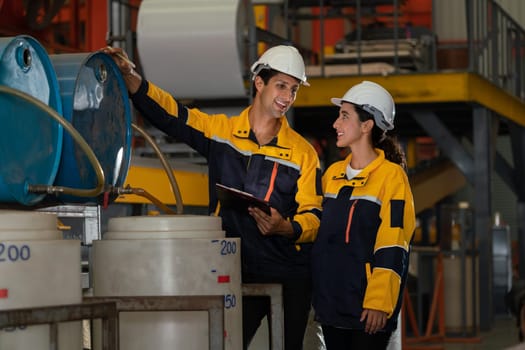 Two factory workers or engineers conduct professional inspection on machine or procedure in chemical plant, chemistry factory workplace and industrial profession concept. Exemplifying