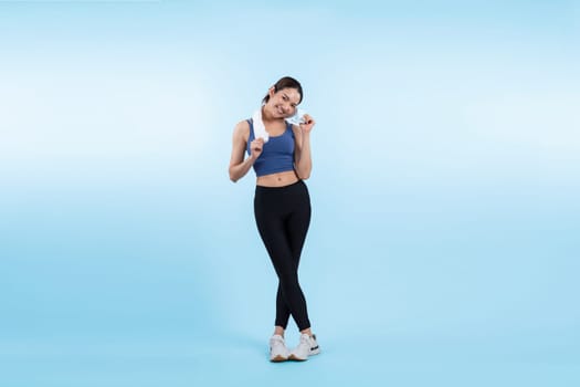 Full body asian woman in sportswear portrait, smiling and posing cheerful gesture. Workout training with attractive girl engage in her pursuit of healthy lifestyle. Isolated background Vigorous