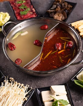 delicious asian bouillon with extra ingredients. View from above. Chinese cuisine, ingredient for hotpot