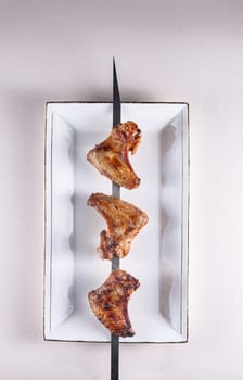 fried chicken wings on a skewer.BBQ. View from above. Chinese cuisine