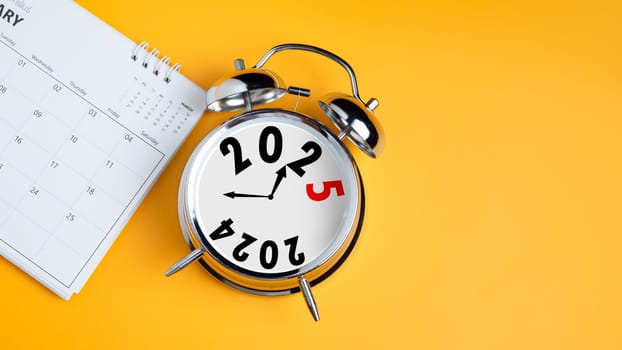 Close-up of calendar and clock alarm clock on yellow background with copy space. Transition from 2023 to 2024, Business startup plan, Countdown starting to 2024, Schedule calendar strategy future.