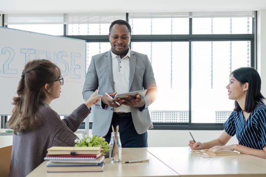 Business People Meeting using laptop computer,calculator,notebook,stock market chart paper for analysis Plans to improve quality next month. Conference Discussion Corporate Concept...