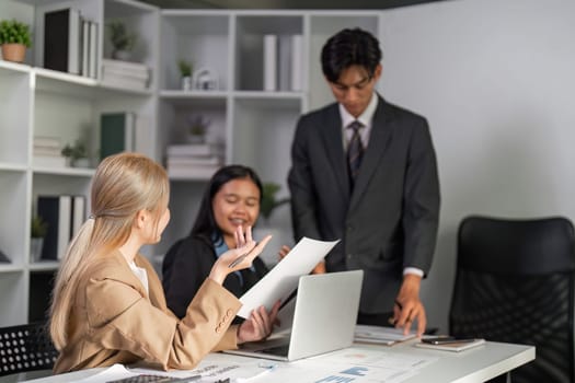 Business professionals collaborate and exchange ideas during a meeting in a contemporary office setting.