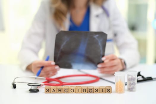 A skilled doctor is examining Xray results related to sarcoidosis patients for accurate diagnosis and care