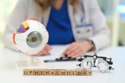 A model eye and visual testing tools highlight the complex field of ophthalmology in a clinical setting