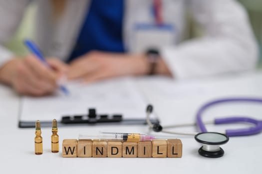A dedicated healthcare worker carefully documents important notes while a stethoscope and medical vials are visible