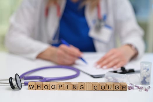 A healthcare professional thoroughly documents the symptoms of whooping cough in a clinical environment setting