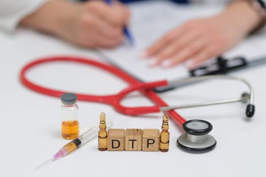 A dedicated medical professional carefully preparing a DTP vaccine while utilizing a stethoscope and syringes