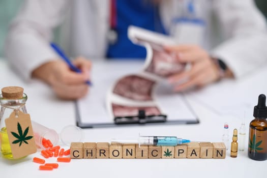 A healthcare professional conducting an assessment of various chronic pain treatment options, including cannabis