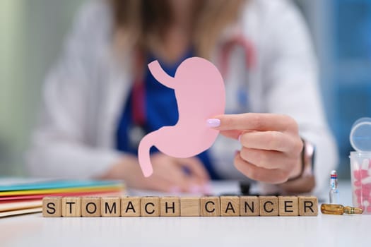 A healthcare professional utilizes various visual aids to significantly enhance the understanding of stomach cancer