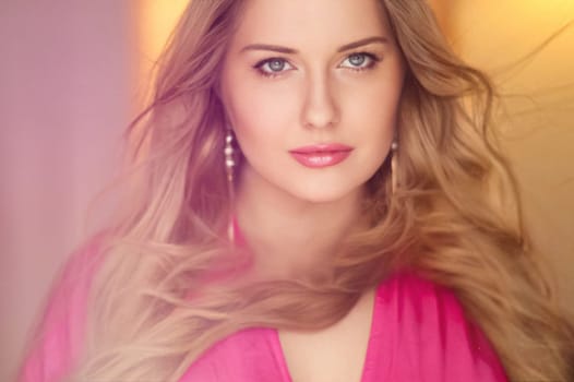 Woman with blue eyes and long, voluminous blonde hair styled in soft curls, wearing pink dress and elegant earrings, dreamy and feminine look idea
