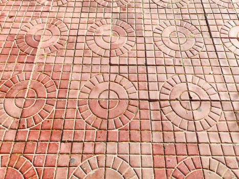 Detailed paving stones featuring circular designs create an attractive outdoor surface suitable for pathways or garden spaces.