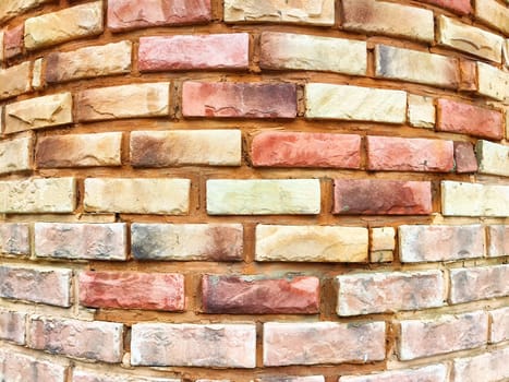 Rustic brick wall with an intricate pattern showcasing warm earth tones and a textured surface, perfect for creative design backgrounds.