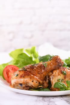 Fried chicken drumstick with gravy and vegetable side dish