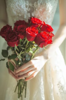 close up of a bouquet of red roses in hands. Selective focus.
