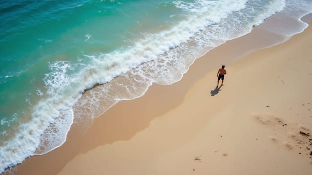 A man is walking on the beach near the ocean. The beach is sandy and the water is calm. The man is wearing a black shirt and shorts