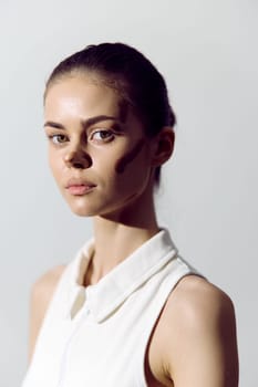 Stunning portrait of an elegant model with artistic makeup, emphasizing natural beauty and confidence against a soft, minimalist background, perfect for fashion and beauty themes.