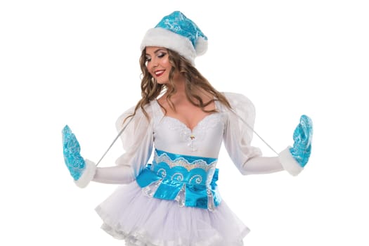 A joyful performer wears a white and blue costume, twirling playfully while showcasing her colorful accessories against a plain background.