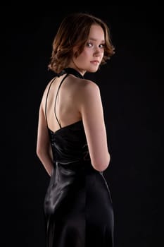 A captivating portrait of a stunning model in a sleek black dress, showcasing elegance and beauty effortlessly