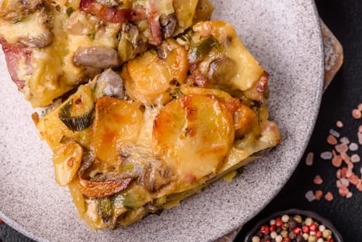Shepherd's pie with potatoes, meat, vegetables, salt, spices and herbs on dark concrete background