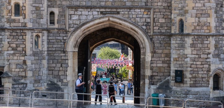 Windsor United Kingdom - August 12 2024; Arch entrance and exit to Windsor Castle with police standing from behind.
