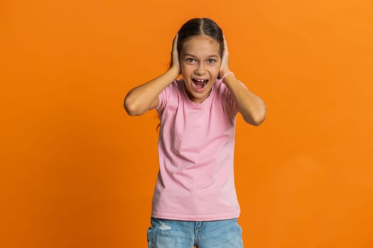 Don't want to hear, listen. Frustrated annoyed irritated young cute school girl covering ears gesturing No, avoiding advice ignoring unpleasant noise loud voices. Preteen female child kid 10 years old