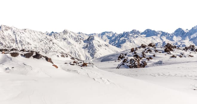 Panorama of winter mountains covered in snow isolated on white background. Mountain peaks in winter