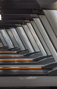 Bangkok, Thailand - Jan 18, 2025 - Perspective view of Treadmill at fitness center. Side view of Treadmill machines in the morning with sunlight, use it as your Wallpaper, Poster and Copy space, Selective focus.