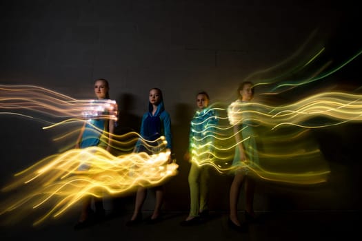 Young dancers in colorful dresses full-length digitally enhanced shot