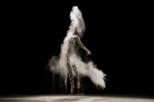 Graceful woman wearing smart striped body in dust cloud view in the dark room