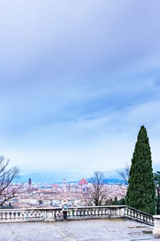 Woman looking at Florence from above on a winter day