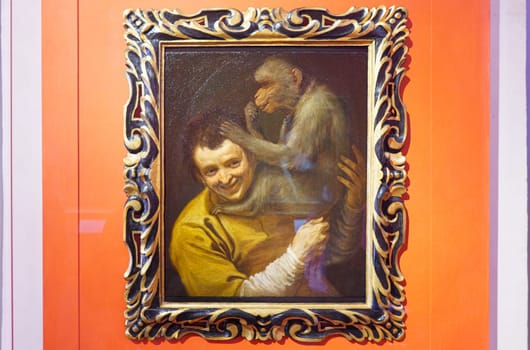 Florence, Italy, January 4, 2024: Young man with a monkey. Annibale Carracci. Uffizi gallery