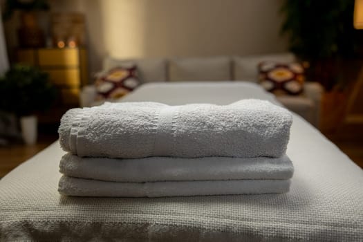 An incredibly serene spa ambiance is created with neatly stacked towels, ensuring a truly calming experience