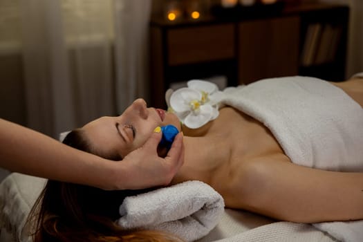 Experience a serene and calming facial treatment that includes soothing massage stones and a tranquil ambiance