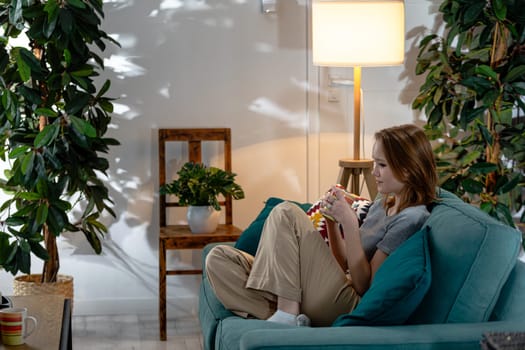 A serene indoor atmosphere showcasing a person sitting comfortably on a couch surrounded by beautiful plants