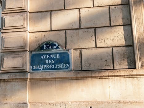 Central street name sign The Avenue des Champs-Elysees. Paris, France - January 18, 2025