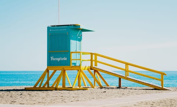 A lifeguard tower constructed on a beach, complete with a ramp that provides easy access leading up to it for safety purposes