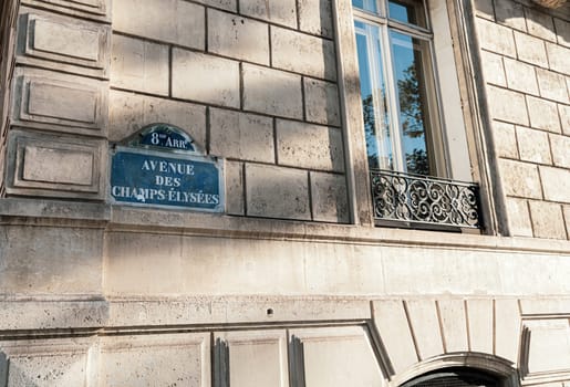 Central street name sign The Avenue des Champs-Elysees. Paris, France - January 18, 2025
