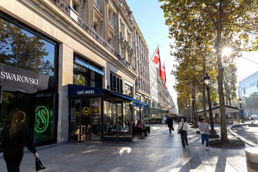 Central street of Paris The Avenue des Champs-Elysees with luxury shops and street life. Paris, France - November 24, 2024
